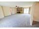 Bright living room featuring a stone fireplace, plush carpet, and sliding door to patio at 10827 Wonderland Dr, Indianapolis, IN 46239