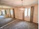 The light and bright living room features wall to wall mirrored accent wall and modern light fixture at 10827 Wonderland Dr, Indianapolis, IN 46239