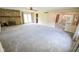Spacious living room with a stone fireplace, plush carpeting, and abundant natural light at 10827 Wonderland Dr, Indianapolis, IN 46239