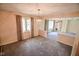 Cozy living room featuring neutral carpet and contemporary chandelier at 10827 Wonderland Dr, Indianapolis, IN 46239