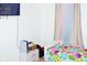 Bright bedroom with a flat-screen TV, colorful bedding, and a charming window with pastel-colored curtains at 10835 Spirit Dr, Ingalls, IN 46048