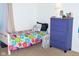 A small bedroom with a twin bed, fan, dresser and carpeted floors at 10835 Spirit Dr, Ingalls, IN 46048