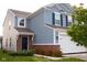 Two-story home with light blue siding, a brick-accented entryway, and a well-maintained lawn at 10835 Spirit Dr, Ingalls, IN 46048