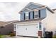Two-story home featuring light blue siding and a two-car garage at 10835 Spirit Dr, Ingalls, IN 46048