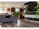 Open-concept living area featuring a stylish sofa, hardwood floors, and a view into the kitchen at 10835 Spirit Dr, Ingalls, IN 46048