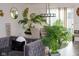 Open floor plan features a grey couch and dining area with plants and light colored walls at 10835 Spirit Dr, Ingalls, IN 46048
