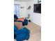 Spacious living room with a blue sofa, decorative wall art, and a flat-screen TV for entertainment at 10835 Spirit Dr, Ingalls, IN 46048