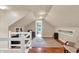 Finished attic space featuring storage, hardwood floors, and open entry at 1107 N Hartman Dr, Indianapolis, IN 46219