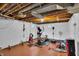 Unfinished basement featuring a workout area and exposed ceiling at 1107 N Hartman Dr, Indianapolis, IN 46219