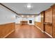 Spacious basement area with wood paneling and a fireplace, perfect for entertaining at 1107 N Hartman Dr, Indianapolis, IN 46219