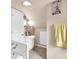 Bathroom with a sink, toilet, and bath with tile floors and natural lighting at 1107 N Hartman Dr, Indianapolis, IN 46219