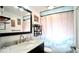 Elegant bathroom featuring a marble vanity, framed mirror, and stylish shower curtain at 1107 N Hartman Dr, Indianapolis, IN 46219