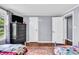 Bright bedroom featuring two beds, wood floors, and an accent chest at 1107 N Hartman Dr, Indianapolis, IN 46219