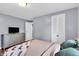 Well-lit bedroom featuring a TV, wood floors, and a large dresser at 1107 N Hartman Dr, Indianapolis, IN 46219