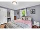 Neutral toned bedroom filled with natural light featuring wood floors at 1107 N Hartman Dr, Indianapolis, IN 46219