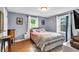 Comfortable bedroom showcasing ample natural light and hardwood floors at 1107 N Hartman Dr, Indianapolis, IN 46219