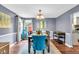 Dining room with a wooden table, blue chairs, and an open view to the adjacent kitchen at 1107 N Hartman Dr, Indianapolis, IN 46219