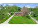 Well-maintained home on a lush lot featuring a driveway, and mature trees at 1107 N Hartman Dr, Indianapolis, IN 46219