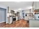 Modern kitchen with stainless steel appliances, white cabinets, and hardwood floors at 1107 N Hartman Dr, Indianapolis, IN 46219