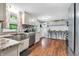 Bright kitchen with stainless steel appliances, granite countertops, and hardwood floors at 1107 N Hartman Dr, Indianapolis, IN 46219