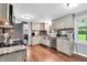 Updated kitchen featuring stainless steel appliances, granite counters, and wood floors at 1107 N Hartman Dr, Indianapolis, IN 46219