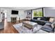 Cozy living room with a fireplace, television, comfortable seating, and hardwood floors at 1107 N Hartman Dr, Indianapolis, IN 46219