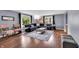 Inviting living room with hardwood floors, a comfortable sectional sofa, and neutral-toned walls at 1107 N Hartman Dr, Indianapolis, IN 46219