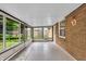 Bright sunroom filled with natural light through many large windows at 1107 N Hartman Dr, Indianapolis, IN 46219