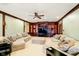 Finished basement with built-in shelving, entertainment center, ceiling fan, and plush sectional sofas at 11319 Shoreview Ln, Indianapolis, IN 46236