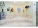 Relaxing bathroom with a large, tiled tub and nautical decor at 11319 Shoreview Ln, Indianapolis, IN 46236