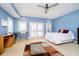 This bedroom features a ceiling fan, natural light, plush carpet, and a door to a private balcony at 11319 Shoreview Ln, Indianapolis, IN 46236