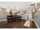 Traditional dining room featuring a long wooden table and hardwood floors, adjacent to the kitchen area at 11319 Shoreview Ln, Indianapolis, IN 46236