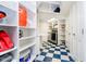 This organized laundry room features tile floors, plenty of shelving, and new appliances at 11319 Shoreview Ln, Indianapolis, IN 46236