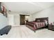 Spacious main bedroom with a barn door to the bathroom, carpeted floors, and a bed at 11319 Shoreview Ln, Indianapolis, IN 46236