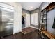 Convenient mudroom with stainless steel refrigerator, storage, and stylish decor, ideal for organization at 11319 Shoreview Ln, Indianapolis, IN 46236