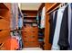 Organized walk-in closet with wooden shelves and hanging rods at 11319 Shoreview Ln, Indianapolis, IN 46236