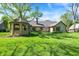 Expansive backyard featuring a covered gazebo, large lawn and exterior elevation of the house at 11471 Clarkston Rd, Zionsville, IN 46077