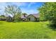 Expansive backyard with lush green lawn, mature trees, and an inviting gazebo at 11471 Clarkston Rd, Zionsville, IN 46077