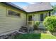 Back porch with steps to the yard, green grass, and light yellow siding at 11471 Clarkston Rd, Zionsville, IN 46077