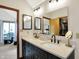 Bathroom featuring double vanity with modern fixtures and mirror, as well as an adjacent closet at 11471 Clarkston Rd, Zionsville, IN 46077