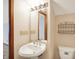 Cozy bathroom with a pedestal sink, decorative shelf and large mirror with Hollywood-style lighting at 11471 Clarkston Rd, Zionsville, IN 46077