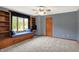 Cozy bedroom with built-in shelves, window seat and neutral carpeting with dark trim at 11471 Clarkston Rd, Zionsville, IN 46077
