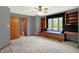 Bedroom featuring a window seat, built-in bookshelves and neutral carpeting with dark trim at 11471 Clarkston Rd, Zionsville, IN 46077