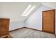 Attic bedroom with skylight, neutral carpet, and wood trim at 11471 Clarkston Rd, Zionsville, IN 46077