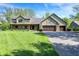 Charming home features an attached three car garage and a well manicured front lawn at 11471 Clarkston Rd, Zionsville, IN 46077