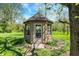 Close up of the backyard gazebo surrounded by grass and various shrubbery at 11471 Clarkston Rd, Zionsville, IN 46077