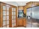 Kitchen featuring stainless steel refrigerator, wood cabinets, granite counters and a breakfast bar at 11471 Clarkston Rd, Zionsville, IN 46077