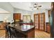 Spacious kitchen with a large island, granite countertops, wooden cabinets, and wood flooring at 11471 Clarkston Rd, Zionsville, IN 46077