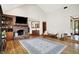 Open living room boasting natural light, a fireplace, and views into the kitchen at 11471 Clarkston Rd, Zionsville, IN 46077
