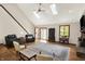 Bright living room boasts vaulted ceilings, skylights, hardwood floors, and a cozy brick fireplace at 11471 Clarkston Rd, Zionsville, IN 46077